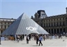 Artist decorates the Louvre's iconic pyramid