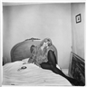 Diane Arbus, Girl in Coat Lying on Her Bed, N.Y.C