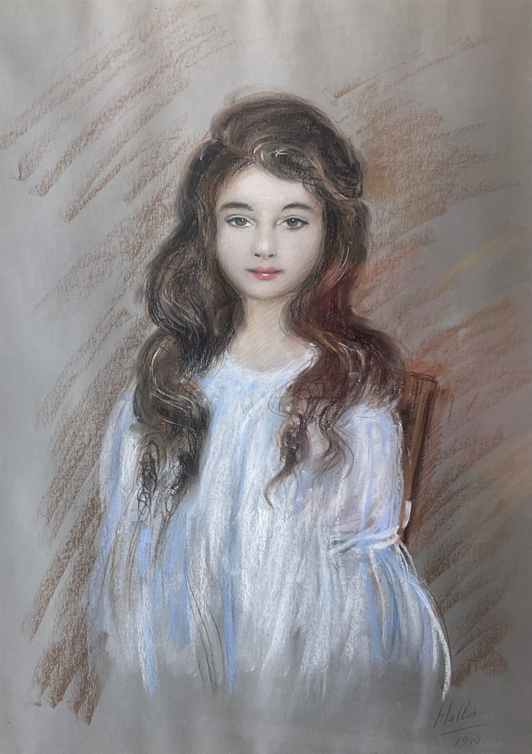 Portrait of a charming young girl with long hair that turned her