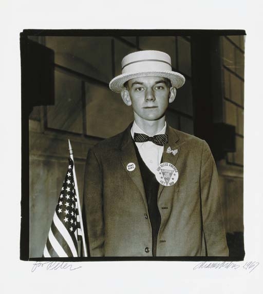Artwork by Diane Arbus, Boy with a straw hat waiting to march in a pro-war parade, N.Y.C., Made of gelatin silver print
