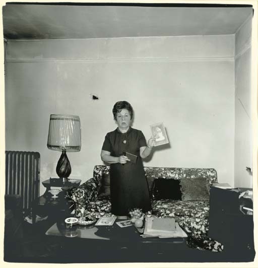 Taxi driver's wife showing picture, N.Y.C., 1968