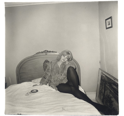 Girl in a coat lying on her bed, N.Y.C. 1968