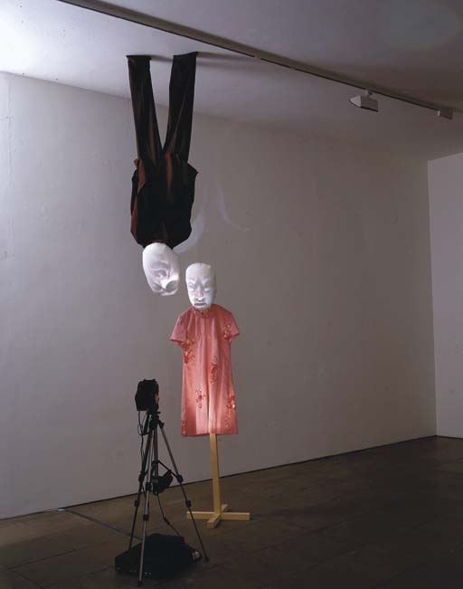 Artwork by Tony Oursler, Inversion, Made of wooden stand, VHS tape, player and projector