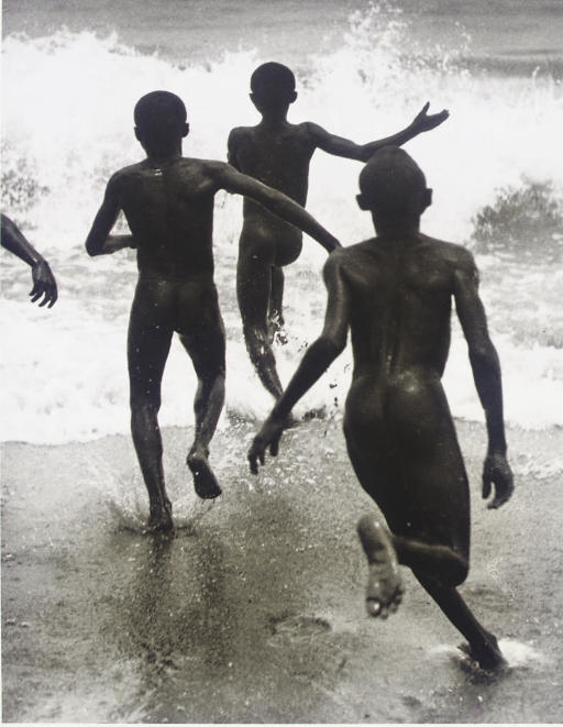 Boys running into the surf at Lake Tanganyika, Liberia, circa 1930 by Martin Munkacsi, printed 2000