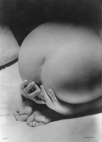 A black-and-white close-up of a figure's backside with hands resting on the hips.