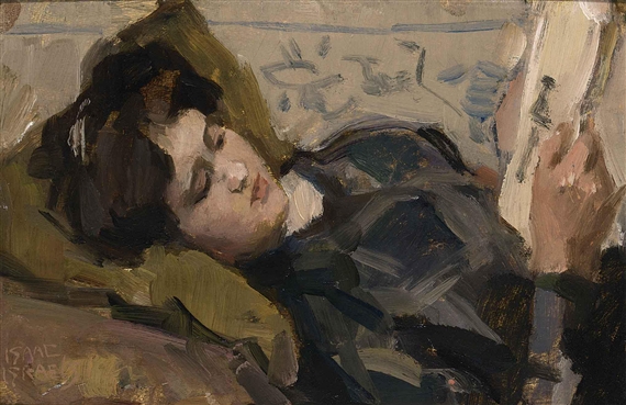 A RECLINING GIRL LOOKING AT A PRINT