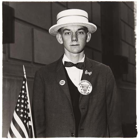 Boy with a straw hat waiting to march in a pro-war parade, N.Y.C. by Diane Arbus, 1967