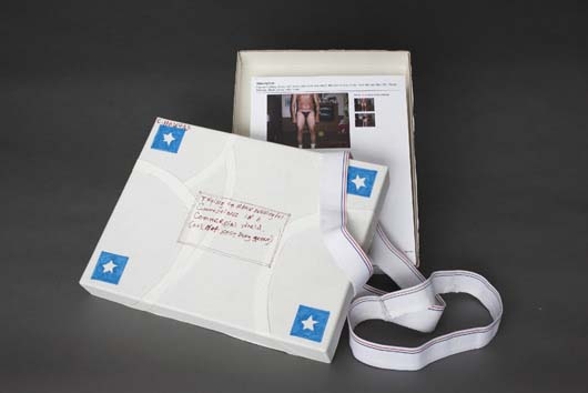 Artwork by Christian Holstad, Trying to Make Meaningful Connections in a Commercial World (It's Not Easy Being Green), Made of Cardboard portfolio laid with cotton with elastic bands and felt-tipped pen containing printed paper.  