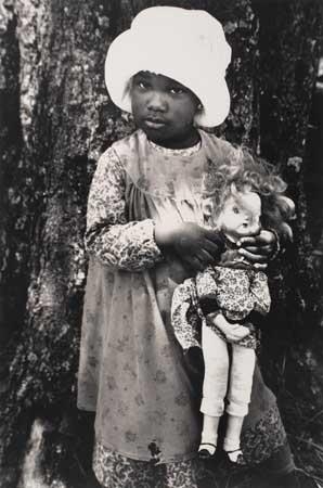Young child with doll (from the film "The Color Purple") by Gordon Parks, 1985