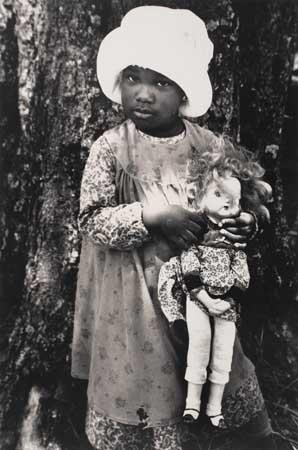Artwork by Gordon Parks, Young child with doll (from the film "The Color Purple"), Made of Silver print