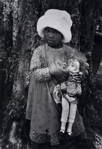 Young child with doll (from the film "The Color Purple") by Gordon Parks, 1985