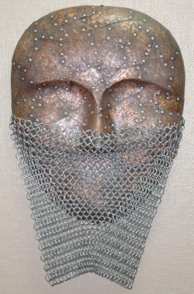 Artwork by Jeff de Boer, MASK, Made of copper and mixed metal wall sculpture
