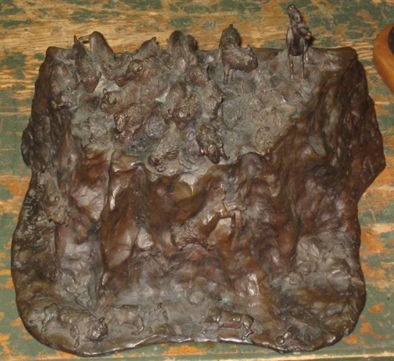 A textured bronze sculpture depicting a chaotic battle scene with numerous small figures.