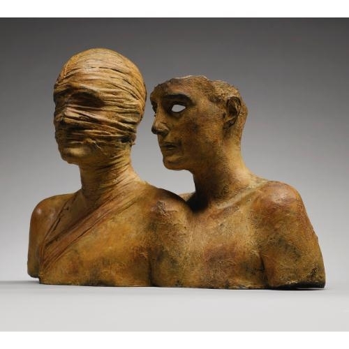 A bronze sculpture of two figures, one blindfolded and the other gazing forward.