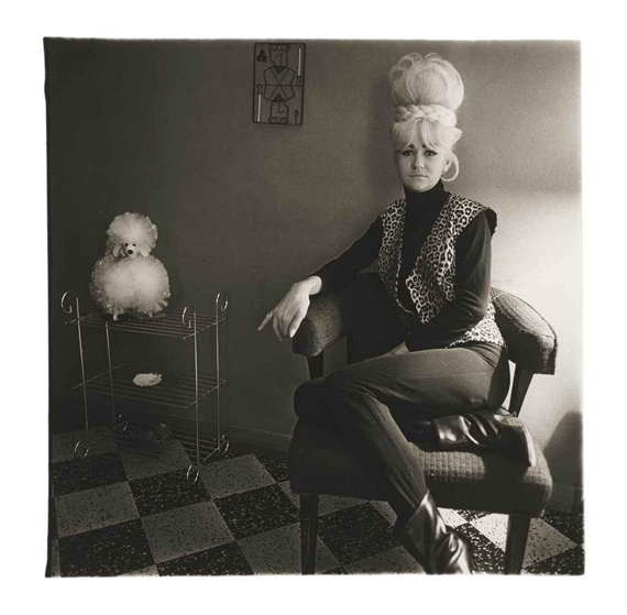 Lady bartender at home with a souvenir dog, New Orleans, 1964 by Diane Arbus, 1964