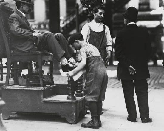 Shoe shine boy working by Lewis Hine, Circa 1910