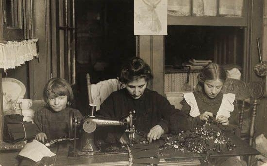 Two works: Woman and two girls sewing at home * Family at home