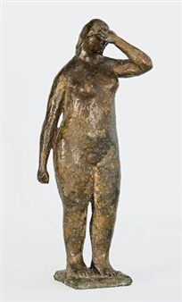 A bronze sculpture of a standing figure with one hand raised to the head.
