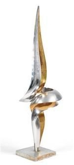 A sleek, abstract sculpture featuring a sharp, upward-pointing form with metallic and gold accents.