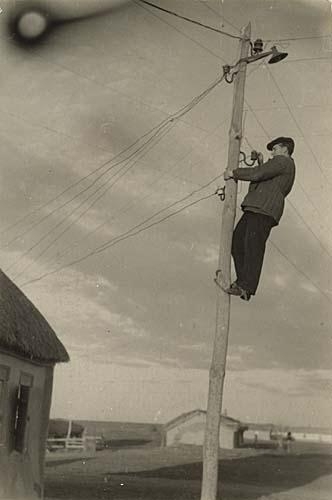 Man on telephone pole by Georgi Zelma, 1936