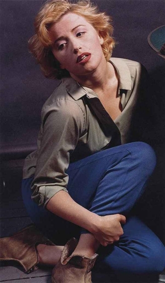 "A candid portrait of a woman in casual attire, captured with soft lighting and a relaxed pose."
