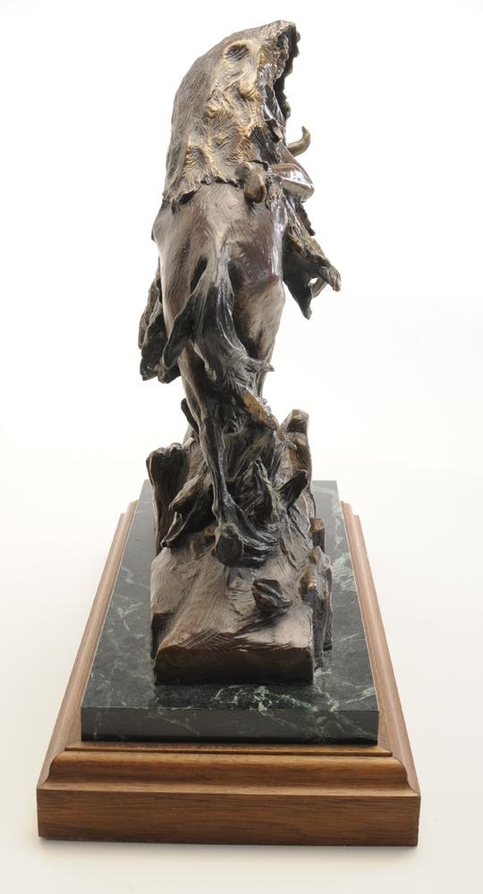 Artwork by Judith Bull, sculpture depicting a Native American on horseback, buffalo hide on horse and rider, rocky crag, Made of polychromed patina