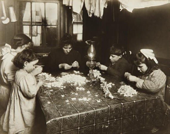 This was the high-tide of tenement homework in New York City when children like these worked at flower-making, 1912 by Lewis Hine, printed 1920s