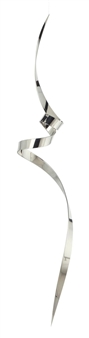 A sleek, metallic ribbon sculpture spiraling vertically against a stark white background.