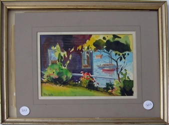 A framed watercolor painting of a lakeside house with boats and trees.