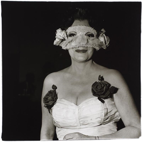 Lady at a masked ball with two roses on her dress, N.Y.C. by Diane Arbus, 1967