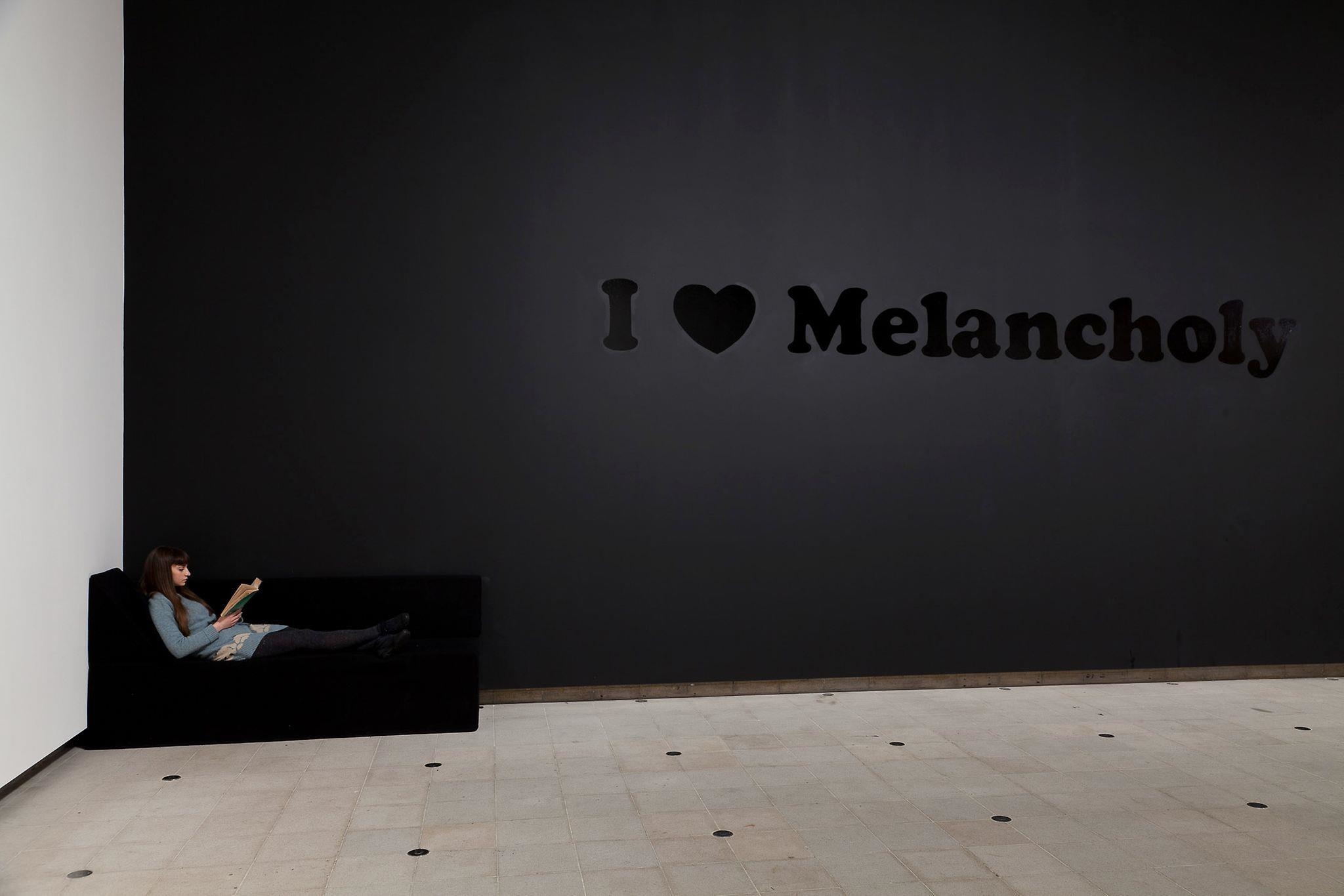 Artwork by Jeremy Deller, I Love Melancholy, Made of wall painting comprising stencilled text in black gloss paint on black matt paint