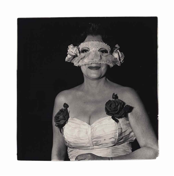 Lady at a masked ball with two roses on her dress by Diane Arbus, 1967