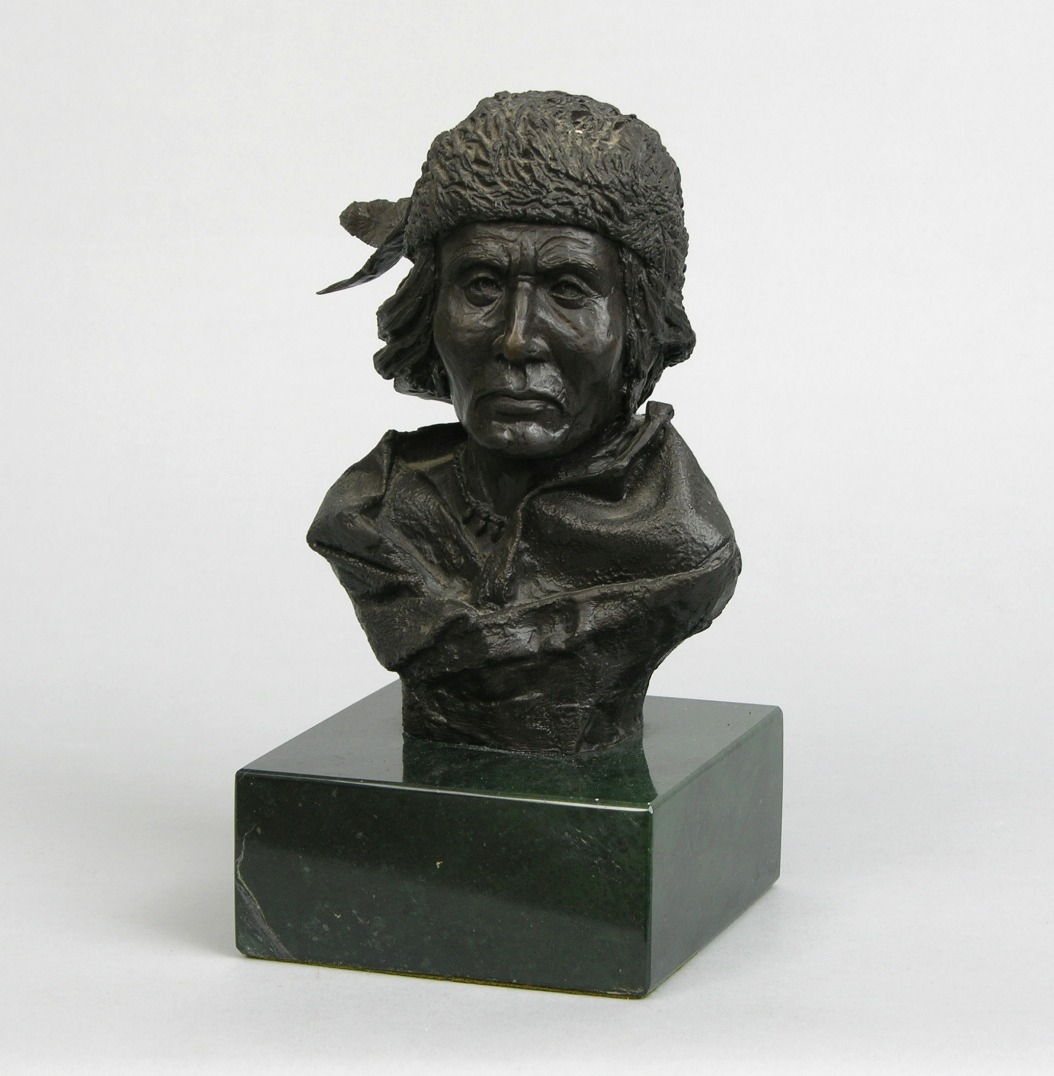 Artwork by Craig Baldwin, Bust of a Native American, Made of Bronze on a dark green marble
