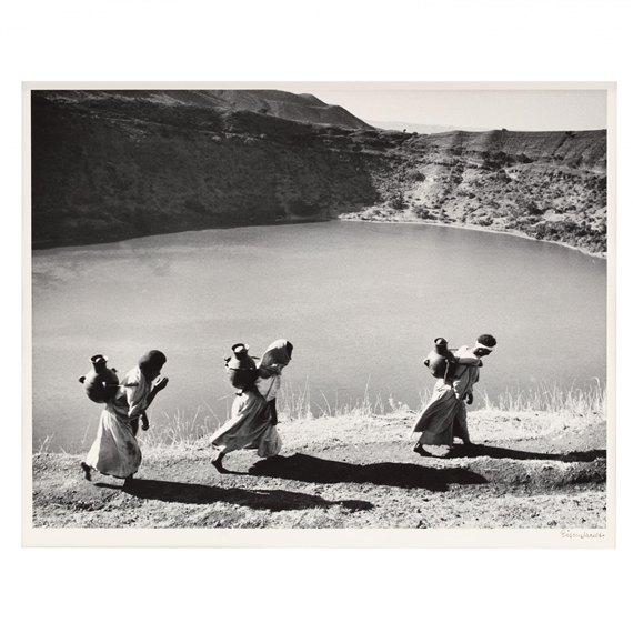 Women carrying water jugs above a crater lake by Alfred Eisenstaedt, circa 1955
