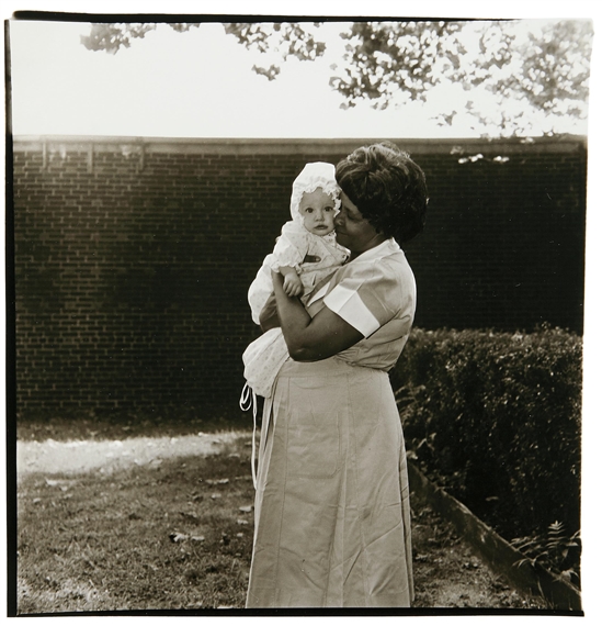 Toddler being held in garden, N.J by Diane Arbus, 1968