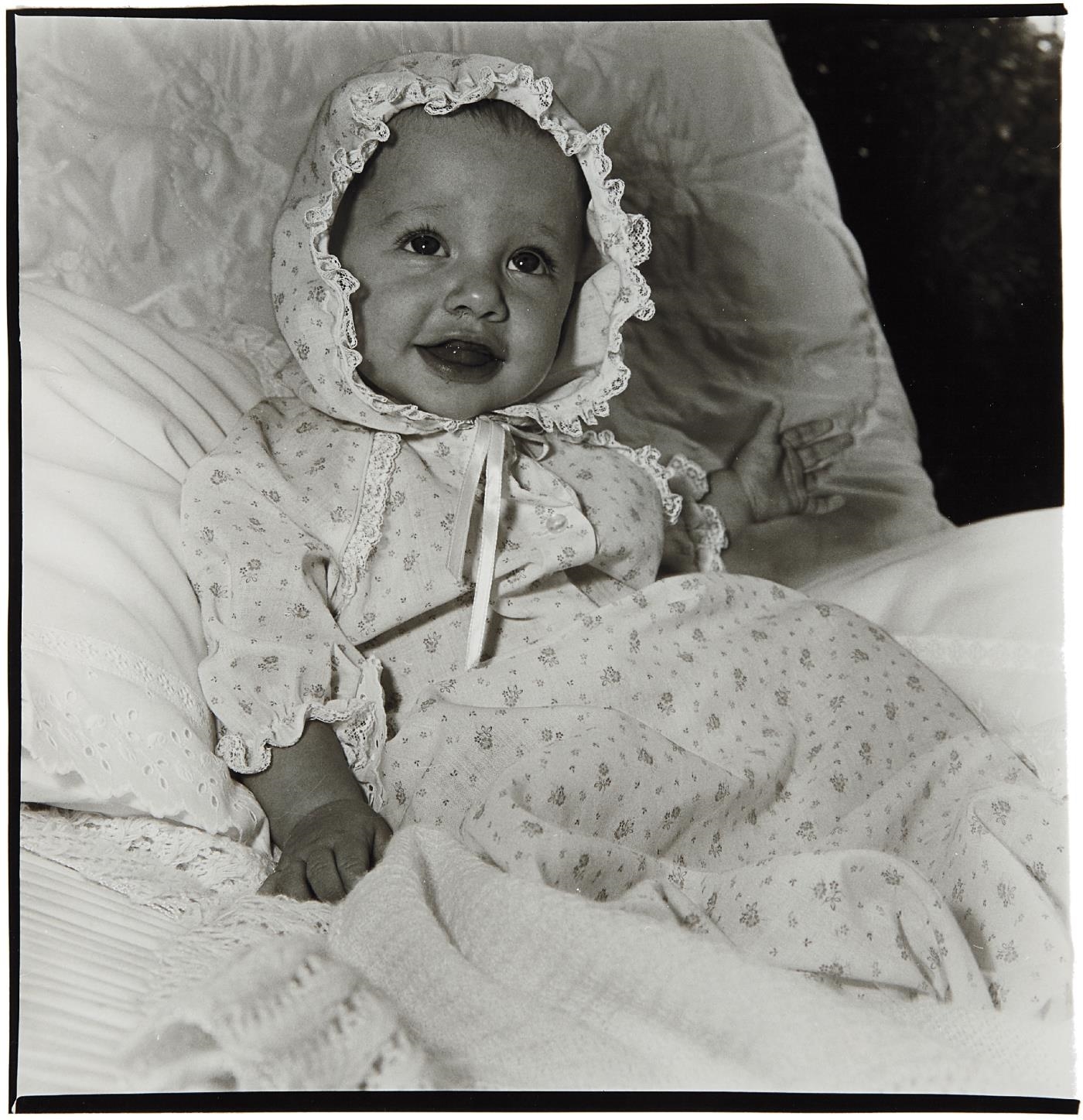 Artwork by Diane Arbus, Baby in a lacey bonnet, N.Y.C, Made of Gelatin silver print