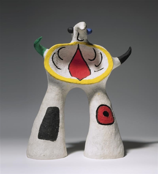 A ceramic sculpture of a cow with horns on its head.