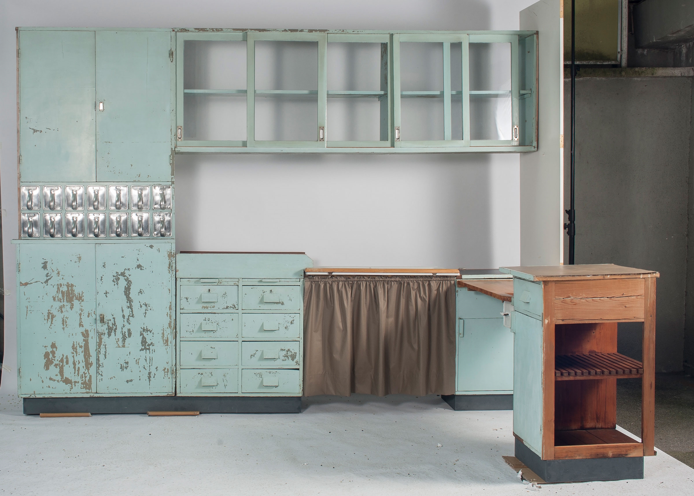 Artwork by Margarete Schütte-Lihotzky, Several kinds of wood, specifically chosen according to purpose, Made of painted blue, sink of cast metal, enamelled white, brass with patina, black linoleum, twelve aluminium containers