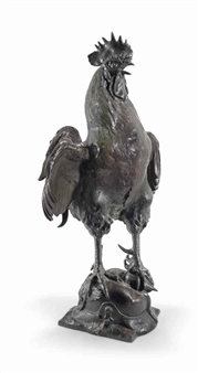 A bronze sculpture of a rooster standing triumphantly over a small animal.