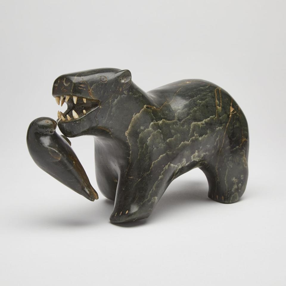 Artwork by Levi Nungaq, POLAR BEAR EATING SEAL, Made of stone, ivory, sinew