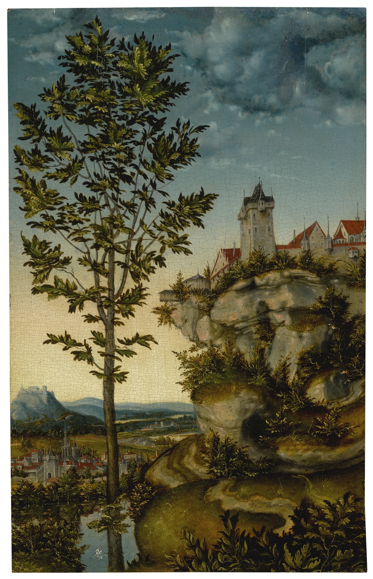 LANDSCAPE WITH FORTIFIED BUILDINGS ON A ROCKY BLUFF, A TREE IN THE LEFT FOREGROUND AND A DISTANT VIEW OF A TOWN BEYOND