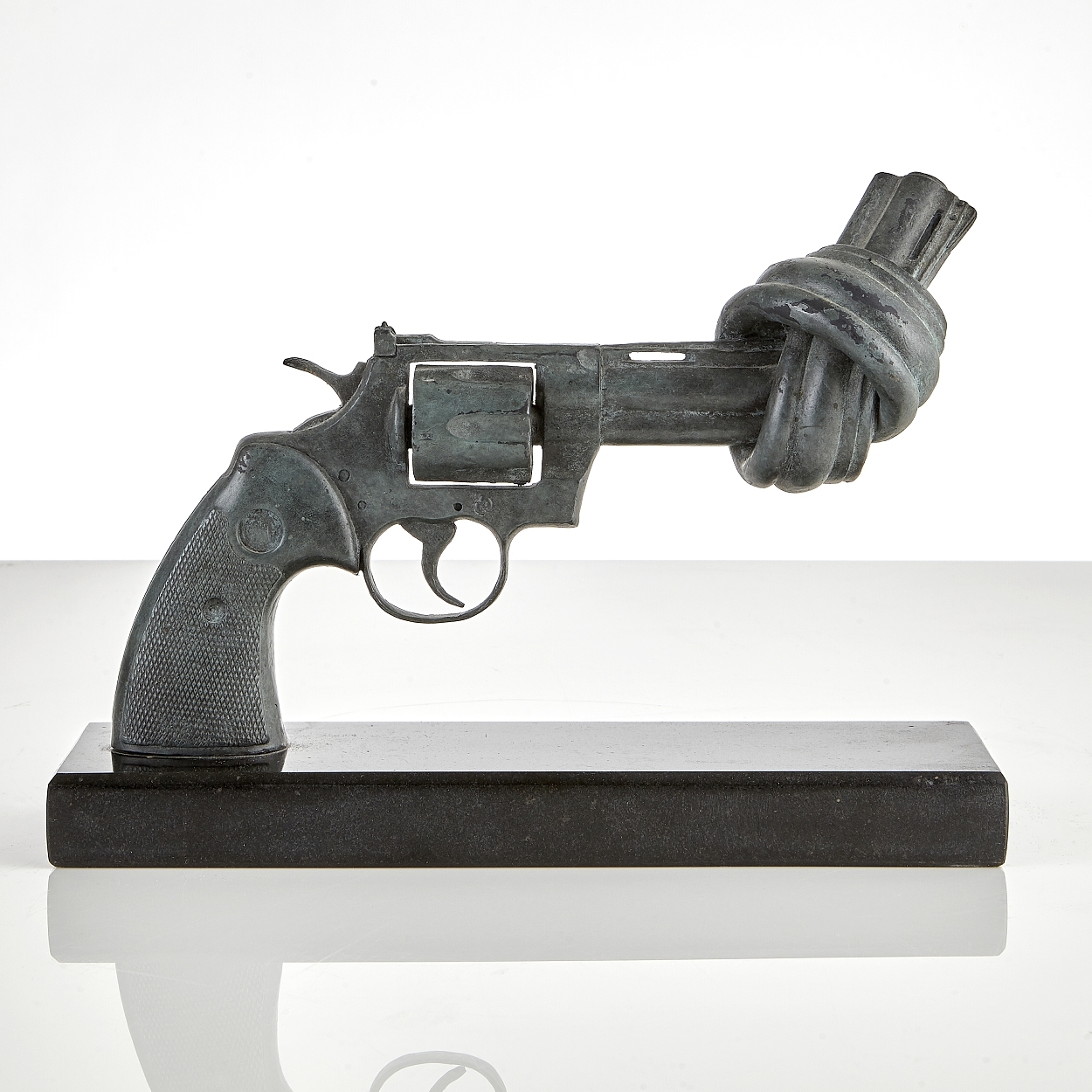 Artwork by Carl Fredrik Reuterswärd, Non violence - In memory of  John Lennon, Made of Green patina bronze