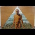 A surreal portrait of a nude figure standing within a triangular frame against a wooden background.