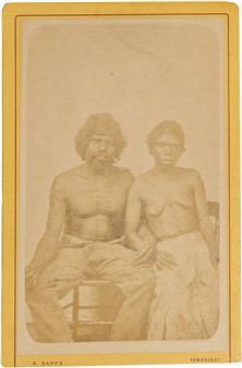 Aboriginal man and woman sitting with linked arm, man has chest lines - Alfred Wren