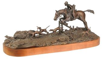 A bronze sculpture capturing a dynamic hunting scene with a rider and dogs.