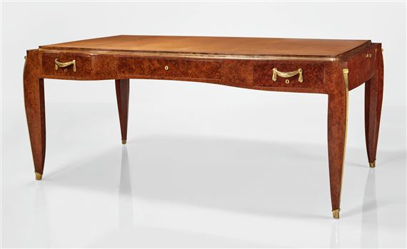 A polished wooden writing desk with curved legs and brass hardware.