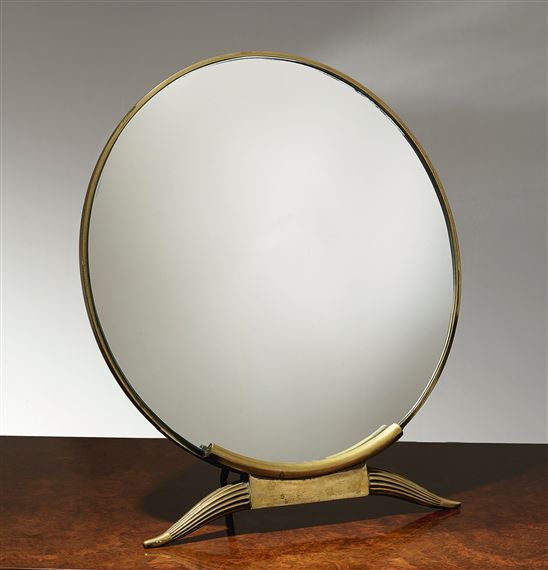 A vintage-style vanity mirror with a brass frame and curved wooden legs.