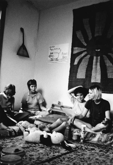 Charlotte Bunch with members of the Furies in the living room of one of their collective houses by Joan E. Biren, 1971; printed 1997