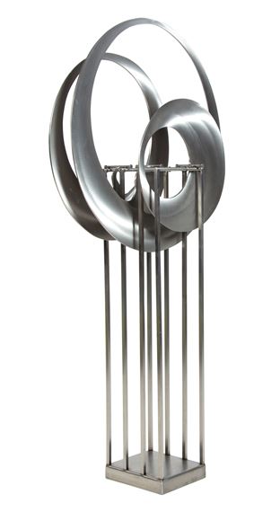 A sleek, metallic sculpture featuring interlocking rings and vertical bars.