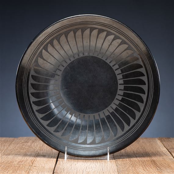 with light gunmetal finish; feather design; signed on reverse, height 1.25 in. x diameter 12.5 in.
1943 - 1954 by Maria Montoya Martinez, Santana Roybal Martinez, 1943 - 1954